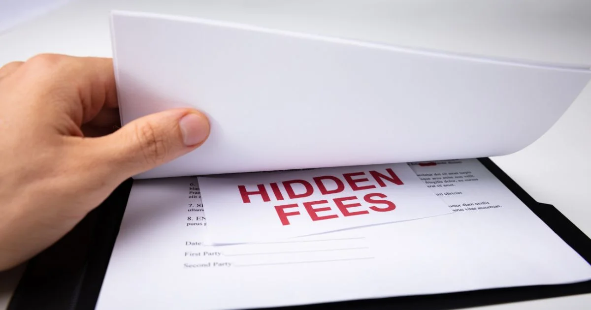 Document revealing hidden fees under lifted paper